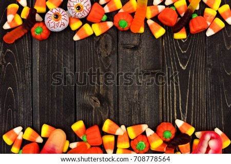 Halloween candy double border over a dark black wood background