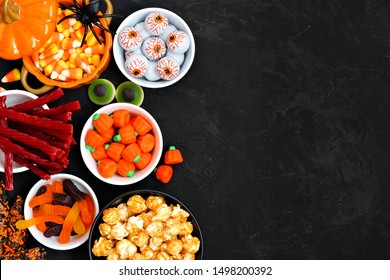 Halloween candy side border over a black stone background with copy space. Assortment of sweet, spooky treats. Top view. Buffet party food concept. - Powered by Shutterstock