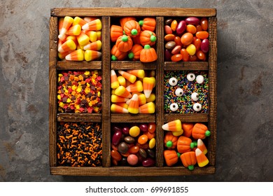 Halloween Candy And Sprinkles In Wooden Box Overhead Shot