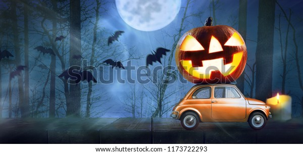 Halloween car delivering pumpkin against night\
scary autumn forest\
background
