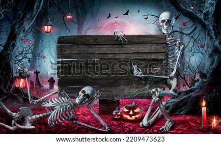 Halloween Card In Forest With Wooden Sign Board - Graveyard At Night With Pumpkins And Skeletons