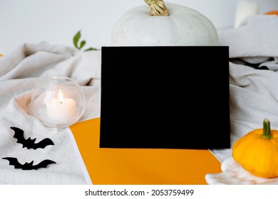 Halloween Card Mockup With Decorations, Pumpkins, Ghosts, Bats On Orange Background. Flat Lay, Top View