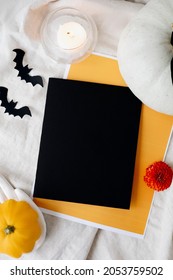 Halloween Card Mockup With Decorations, Pumpkins, Ghosts, Bats On Orange Background. Flat Lay, Top View