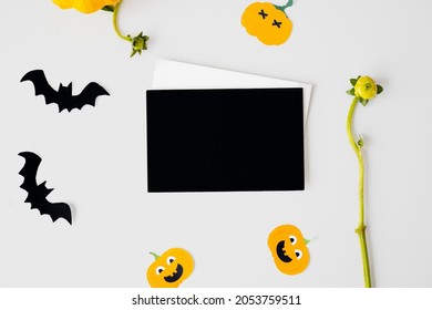 Halloween Card Mockup With Decorations, Pumpkins, Ghosts, Bats On Orange Background. Flat Lay, Top View