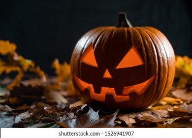 halloween carving pumpkin on a leafs. shining Jack-o'-lantern. - Powered by Shutterstock