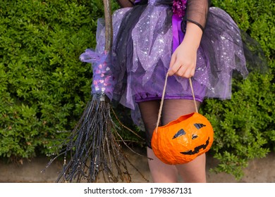 Halloween Closeup Witch Purple Skirt In And With Broomstick And Pumpkin.