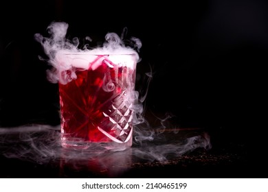 Halloween Cocktail With Dry Ice On Dark Background