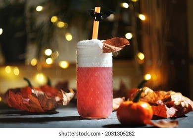 Halloween cocktail party concept. Glass of Halloween drink with cold foam.
