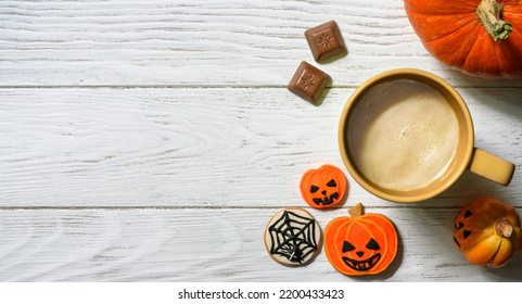 Halloween And Coffee Theme, Orange Pumpkin, Sweets And Cup On White Table, Top View. Holiday Food On Wood Planks Background With Space, Flat Lay. Party, Season, October, Tasty And Breakfast Concept.