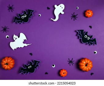 Halloween composition with ghosts, bats, spiders and pumpkins on purple background. Happy halloween banner mockup. Flat lay, top view, copy space. - Shutterstock ID 2215054023