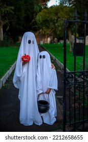Halloween Concept - two little white ghosts with halloween staff - Shutterstock ID 2212658655
