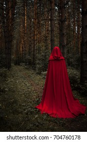 Halloween concept. A witch in a raincoat and a hood. autumn. Photo horizontal for your design.