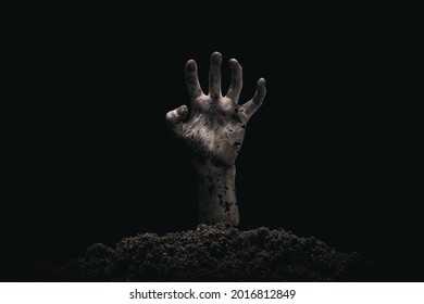 Halloween concept, zombie hand coming out from the grave. Atmosphere of horror.