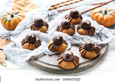 Halloween cookies with chocolate spiders on wooden background - Powered by Shutterstock