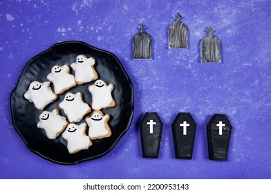 Halloween Cookies And Tombstones On A Purple Background