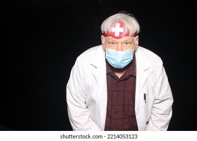 Halloween Costume. Halloween Photo Booth. Photo Booth. An Evil Doctor Poses As He Has His Photo Taken While In A Halloween Photo Booth With Black Velvet Curtains. Beware Of Bad Medicine. 