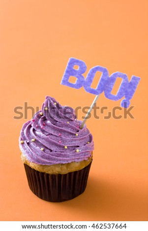 Halloween cupcake on orange background