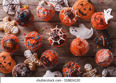 Halloween Cupcakes And Gingerbread Cookies On The Table. Horizontal View From Above
