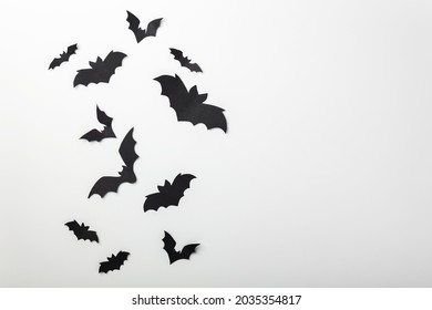 halloween and decoration concept - black paper bats flying over white background, copy space - Powered by Shutterstock