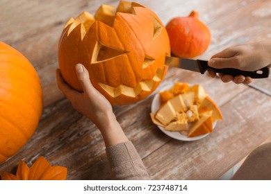 halloween, decoration and holidays concept - close up of woman with knife carving pumpkin or jack-o-lantern at home - Shutterstock ID 723748714