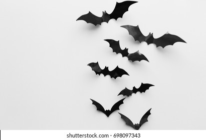 halloween, decoration and scary concept - black bats flying over white background - Powered by Shutterstock