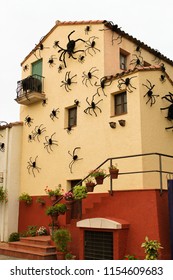 Halloween decoration. Yellow and red house with giant black spiders. Photo taken during holiday in Spain in 2016