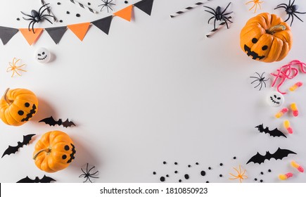 Halloween decorations made from pumpkin, paper bats and black spider on pastel orange background. Flat lay, top view with copy space for text. - Powered by Shutterstock