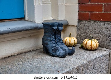 Halloween Decorations On The Doorstep. Witch Boots And Pumpkins Outside