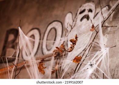 Halloween Decorations White Spider Web On The Background Of A Ghost Painted In Chalk On The Wall Of A Dark Room In The Evening. Horror. Boo