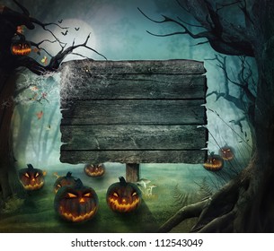 Halloween design - Forest pumpkins. Horror background with autumn valley with woods, spooky tree, pumpkins and spider web. Space for your Halloween holiday text. - Shutterstock ID 112543049
