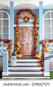 Halloween design home with yellow fall leaves and lanterns. House entrance staircase decorated for autumn holidays, fall flowers and pumpkins. Cozy wooden porch of the house with pumpkins in fall time - Shutterstock ID 2198327571