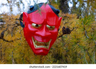 Halloween Devil Mask On A Bush Near The House In The Garden. A Festive Event. Zina, Latvia - 02.11.2022