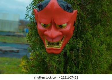 Halloween Devil Mask On A Bush Near The House In The Garden. A Festive Event. Zina, Latvia - 02.11.2022