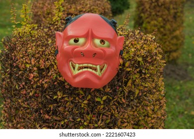 Halloween Devil Mask On A Bush Near The House In The Garden. A Festive Event. Zina, Latvia - 02.11.2022