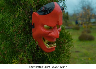 Halloween Devil Mask On A Bush Near The House In The Garden. A Festive Event. Zina, Latvia - 02.11.2022