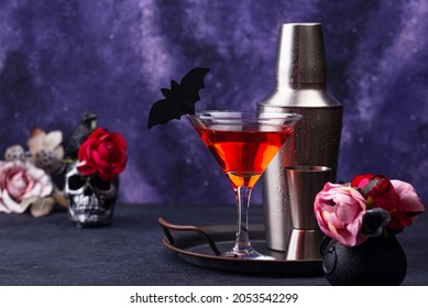 Halloween Drink. Orange Martini Cocktail On Purple Galaxy Background