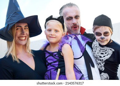 Halloween Family Portrait. A Fun Family Dressed Up For Halloween, Posing Together.