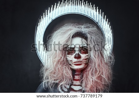 Halloween female skull makeup with creative, artistic lightening.