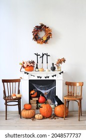 Halloween, fireplace with a variety of festive decor and pumpkins. - Shutterstock ID 2048577737
