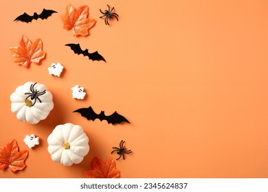 Halloween flat lay composition with pumpkins, spiders, bats, maple leaves on orange background. Happy Halloween holiday concept. Flat lay, top view, copy space. - Shutterstock ID 2345624837