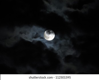 Halloween full moon in pitch black dark skies with clouds