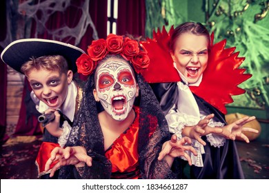 Halloween. Funny Scared Kids In Carnival Costumes Wander Through The Old Castle On Halloween.