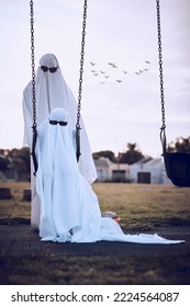 Halloween, Ghost Costumes And Sunglasses In The Park For Scary Family Holiday Celebration Together. Father Or Mother With Child Playing Spooky Dress Up Wearing Sheets To Terrorize The Neighborhood