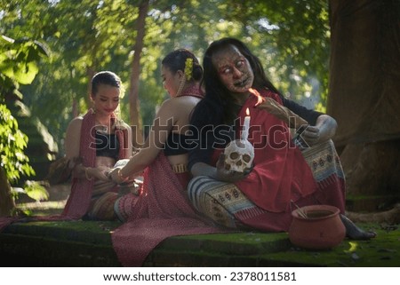 Halloween Ghost and the Devil show pretty Asian women wearing an ancient Local Thai Lanna Traditional Dress costume shows the Thai Ghost typical of the local country. Concept of the horror for funny.