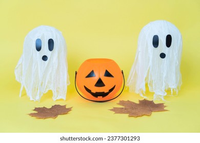 Halloween ghosts made from bandages, glue, water and using balloons and glasses on yellow orange background. Children's art project. DIY concept.  Step by step 8. Halloween holiday concept.  - Powered by Shutterstock