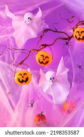 Halloween Ghosts and Pumpkin buckets for candies  over neon purple background. Halloween party concept. Funny holiday decorations. - Shutterstock ID 2198353587