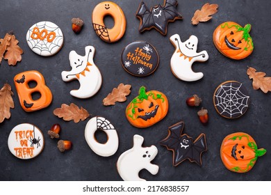Halloween gingerbread cookies on dark stone background. Bright homemade cookies for Halloween party