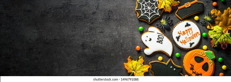 Halloween Gingerbread Cookies - pumpkin, ghosts, witch hat, spiderweb on black background. Top view. - Powered by Shutterstock