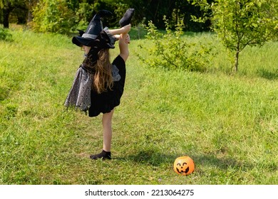 Halloween girl going to collect candy. Trick-or-treating. Guising. Jack-o-lantern. Child in carnival costume witch outdoors. Celebrate halloween. Girl in forest smiling and holding basket of sweets - Shutterstock ID 2213064275