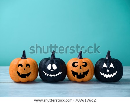 Halloween glitter pumpkin jack o lantern decor with funny faces. 